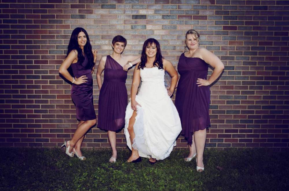 Bridesmaids against a wall